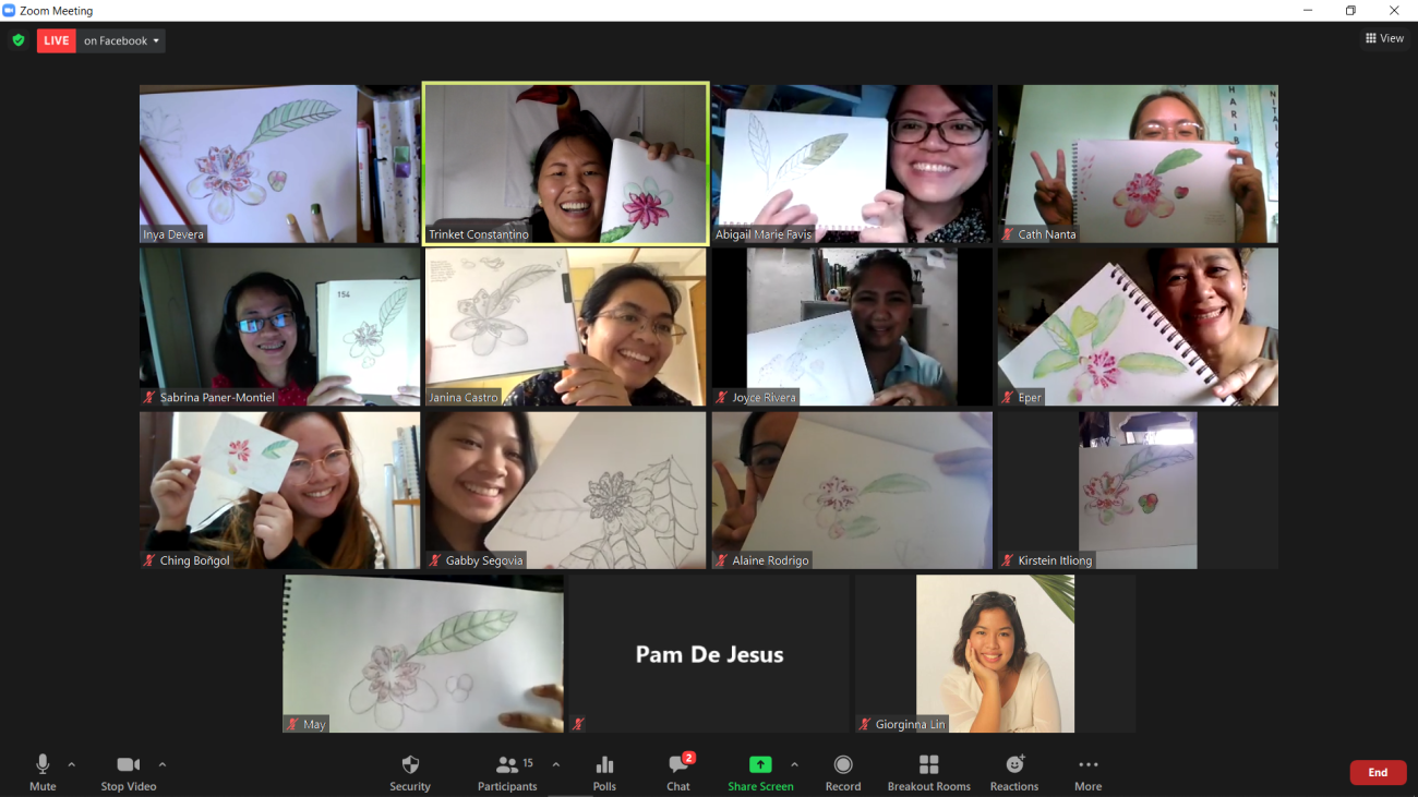 A group photo of the attendees showing off their artworks.