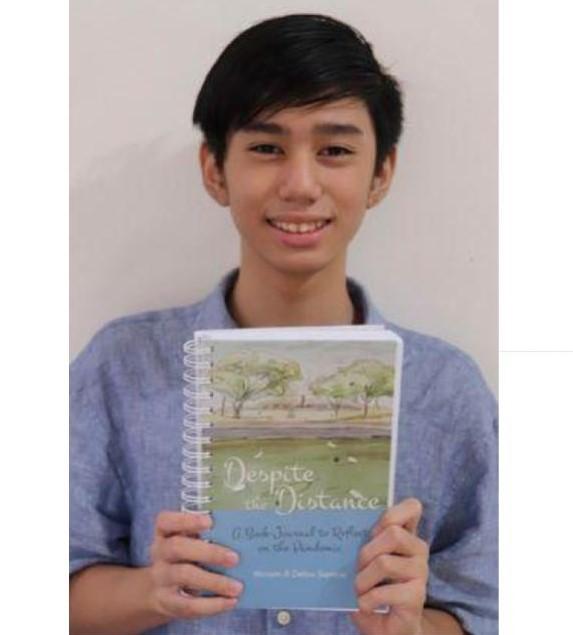 Josh Ong Ante holds up a copy of 'Despite The Distance'