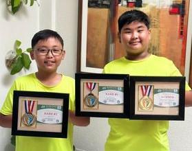 Adrian Cruz and twin brother Aiden pose with their Golfmix awards 