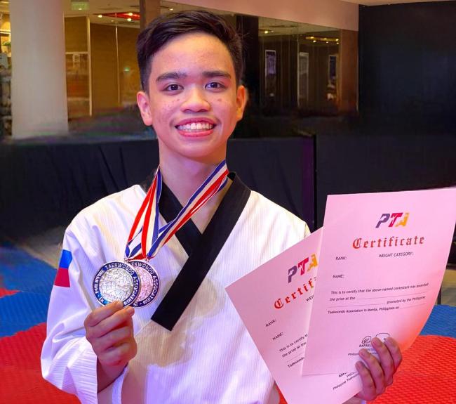 Lucas Llarena with the two medals he won at the 2023 National Poomsa Taekwondo Championships 