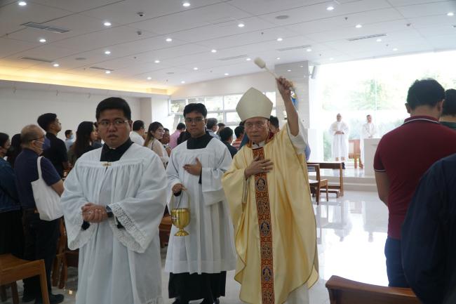 Bishop Honesto Ongtioco sprinkles the interior of the St Aloysius Gonzaga Chapel with holy water
