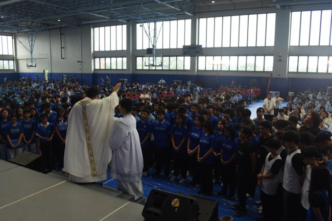 ASHS athletes are prayed over by Fr Noel Bava SJ during the ASHS Cheer Rally 