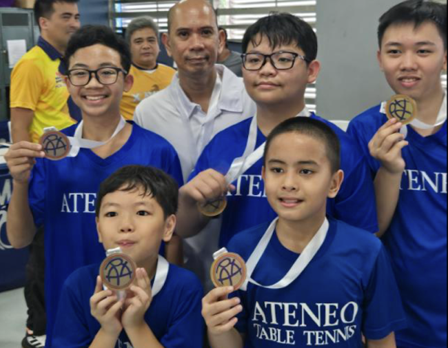(clockwise from left) Micael Pacia, Coach Leo Raymundo, Ethan Chase Daya, Altair Capistrano, Titus Pachica, Sebastian Rafael Tongson