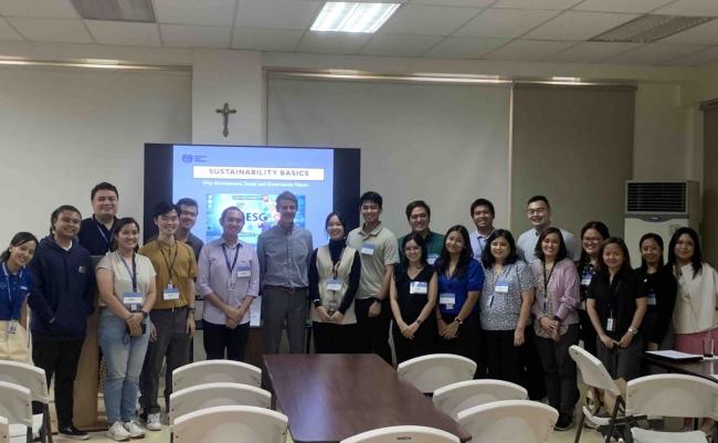 Guests, colleagues, and members of the community partake in a group photo. Photo by AIS.