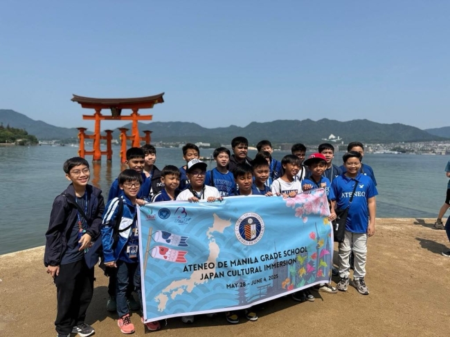 The Ateneans at Itsukushima Shrine's Torii Gate on Miyajima Island. The Shrine is a UNESCO World Heritage Site.  