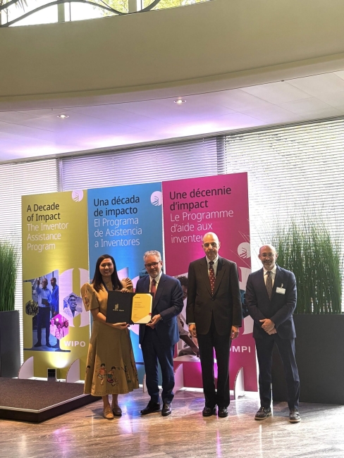 Image: Ms. Malapit receiving her IAP Certificate of Volunteer Recognition