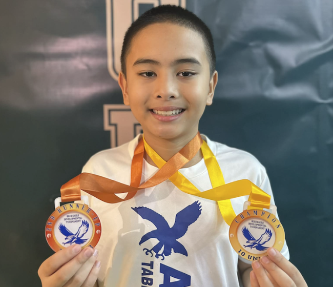 Titus Pachica  with his gold and bronze medals from the Blue Eagle tournament 