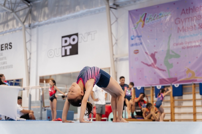 Andi Favis showcasing her skills in the floor event